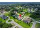 Extensive aerial view showing the house, its landscaped surroundings, and the community in a lush green neighborhood at 2662 Delphi Hills Ct, Lakeland, FL 33812