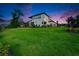 Expansive backyard view of a well-maintained lawn, accented by lush landscaping and a modern home at 2662 Delphi Hills Ct, Lakeland, FL 33812