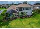 Overhead view of a covered lanai and screened-in pool, all surrounded by well-manicured landscaping at 2662 Delphi Hills Ct, Lakeland, FL 33812