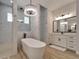 Luxurious bathroom with a freestanding tub, walk-in shower, modern vanity, and decorative chandelier at 2662 Delphi Hills Ct, Lakeland, FL 33812