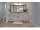 Modern bathroom with a spacious vanity, a large mirror, contemporary lighting, and a walk-in shower at 2662 Delphi Hills Ct, Lakeland, FL 33812