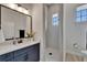 Modern bathroom featuring a walk-in shower, elegant vanity with stylish fixtures and a toilet with a window view at 2662 Delphi Hills Ct, Lakeland, FL 33812