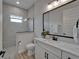 Modern bathroom featuring tiled shower, natural stone countertop, and light fixtures at 2662 Delphi Hills Ct, Lakeland, FL 33812