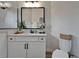 Bright bathroom features a sleek white vanity with modern hardware and a framed mirror at 2662 Delphi Hills Ct, Lakeland, FL 33812