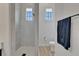 Beautiful bathroom boasts a tiled walk-in shower, toilet and a window, creating a bright, airy ambiance at 2662 Delphi Hills Ct, Lakeland, FL 33812