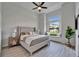 Cozy bedroom with a large window seat, ceiling fan and wood-look flooring at 2662 Delphi Hills Ct, Lakeland, FL 33812