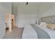 Spacious bedroom boasts wood-look flooring and access to both a walk-in closet and en suite bathroom at 2662 Delphi Hills Ct, Lakeland, FL 33812