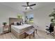Bright bedroom with a woven headboard, ceiling fan, and comfortable furnishings, with natural light from windows at 2662 Delphi Hills Ct, Lakeland, FL 33812