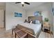 Cozy bedroom with a woven headboard, soft linens, and a decorative bench, featuring natural light at 2662 Delphi Hills Ct, Lakeland, FL 33812