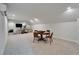 Open bonus room featuring a round game table, comfortable seating, and a large-screen TV for entertainment at 2662 Delphi Hills Ct, Lakeland, FL 33812