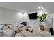 Cozy bonus room featuring a comfy sectional sofa, large flat screen TV, and stylish décor at 2662 Delphi Hills Ct, Lakeland, FL 33812