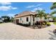 Charming curb view showcasing the house's architecture and design with a brick driveway and landscaped garden at 2662 Delphi Hills Ct, Lakeland, FL 33812