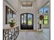 Spacious foyer featuring high ceilings, a modern console table, and a view through double front doors at 2662 Delphi Hills Ct, Lakeland, FL 33812