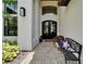Inviting front entrance with double doors, decorated with holiday decor, and bench seating at 2662 Delphi Hills Ct, Lakeland, FL 33812