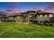 An inviting two-story home with a manicured lawn, flower beds, and decorative trees at 2662 Delphi Hills Ct, Lakeland, FL 33812