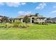 Lush front lawn and beautifully landscaped garden that creates a captivating entrance and complements the home's curb appeal at 2662 Delphi Hills Ct, Lakeland, FL 33812