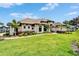 Beautifully landscaped front yard and facade featuring lush green grass, verdant bushes and vibrant flower beds at 2662 Delphi Hills Ct, Lakeland, FL 33812