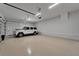 Spacious three car garage with white walls, epoxy floors and ample room for parking and storage at 2662 Delphi Hills Ct, Lakeland, FL 33812