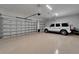 Spacious three car garage with white walls, epoxy floors and ample room for parking and storage at 2662 Delphi Hills Ct, Lakeland, FL 33812