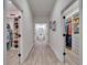 Hallway leading to walk-in closets and a bathroom with a soaking tub, exuding a modern and organized lifestyle at 2662 Delphi Hills Ct, Lakeland, FL 33812