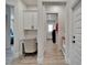 Hallway with built in desk area and sightlines to a laundry room, features neutral walls and modern flooring at 2662 Delphi Hills Ct, Lakeland, FL 33812