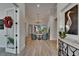 View of the light-filled open living room with modern furniture from entry hall, decorated with elegant artwork at 2662 Delphi Hills Ct, Lakeland, FL 33812