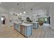 Open kitchen boasts modern appliances, quartz countertops, double islands and seamless transition to living space at 2662 Delphi Hills Ct, Lakeland, FL 33812