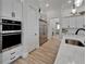 Modern kitchen features stainless steel appliances, white cabinets, and wood flooring at 2662 Delphi Hills Ct, Lakeland, FL 33812