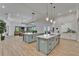 Spacious kitchen features double islands, stainless appliances and easy access to living area and outdoor space at 2662 Delphi Hills Ct, Lakeland, FL 33812