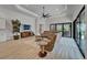 Modern living room features a vaulted ceiling, tan sectional seating area, and backyard views at 2662 Delphi Hills Ct, Lakeland, FL 33812