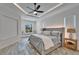 Comfortable main bedroom with a decorative ceiling, a seating area, and neutral decor at 2662 Delphi Hills Ct, Lakeland, FL 33812