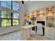 Bright office with large windows features custom built-in shelves, modern furniture, and wood-look flooring at 2662 Delphi Hills Ct, Lakeland, FL 33812