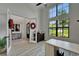 Bright office space features ample natural light, neutral walls, and a stylish desk with view of front yard at 2662 Delphi Hills Ct, Lakeland, FL 33812