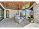 Screened-in patio with stone fireplace, outdoor seating, and an outdoor bar at 2662 Delphi Hills Ct, Lakeland, FL 33812
