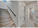 Contemporary staircase with ambient lighting leads to an upstairs hallway, providing access to a bathroom at 2662 Delphi Hills Ct, Lakeland, FL 33812