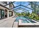 Inviting screened-in pool and spa with lush tropical landscaping and multiple seating areas at 2662 Delphi Hills Ct, Lakeland, FL 33812