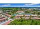 Aerial view of a residential community with a lake, swimming pool, and lush green landscaping at 2683 Corvette Ln, Kissimmee, FL 34746