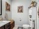 Bathroom features modern fixtures, toilet, vanity, and decorative artwork, enhancing the space at 2683 Corvette Ln, Kissimmee, FL 34746