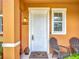 Inviting front porch with chairs and stylish address number on the exterior of this lovely home at 2683 Corvette Ln, Kissimmee, FL 34746