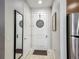 Hallway featuring tile floors, neutral paint, a full length mirror, and entry to the kitchen at 2683 Corvette Ln, Kissimmee, FL 34746