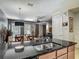 Open floor plan with kitchen featuring stainless steel appliances, granite countertops, and wood cabinets at 2683 Corvette Ln, Kissimmee, FL 34746
