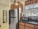Efficient kitchen featuring stainless steel appliances, granite countertops, and wood cabinets at 2683 Corvette Ln, Kissimmee, FL 34746
