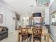 Open concept living room, dining room and kitchen with tile floors and stainless steel appliances at 2683 Corvette Ln, Kissimmee, FL 34746