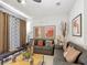 Comfortable living room showcasing elegant curtains, artwork, and plush seating at 2683 Corvette Ln, Kissimmee, FL 34746