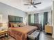 Main bedroom featuring a modern headboard, ceiling fan, and lots of natural light at 2683 Corvette Ln, Kissimmee, FL 34746