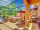 Screened patio with a hot tub, grill, and outdoor dining area at 2683 Corvette Ln, Kissimmee, FL 34746