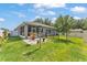 Lush backyard features green grass, patio, landscaping, and dark metal fence creating a cozy space at 280 Pershing St, Bartow, FL 33830