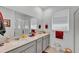 Bathroom featuring a large mirror over dual sinks, great natural light, and a walk-in shower at 280 Pershing St, Bartow, FL 33830