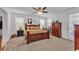 Spacious bedroom with a large bed, carpet flooring, and ample natural light from multiple windows at 280 Pershing St, Bartow, FL 33830