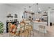 Dining area features a glass-top table with seating for four, adjacent to an open kitchen with pendant lighting at 280 Pershing St, Bartow, FL 33830